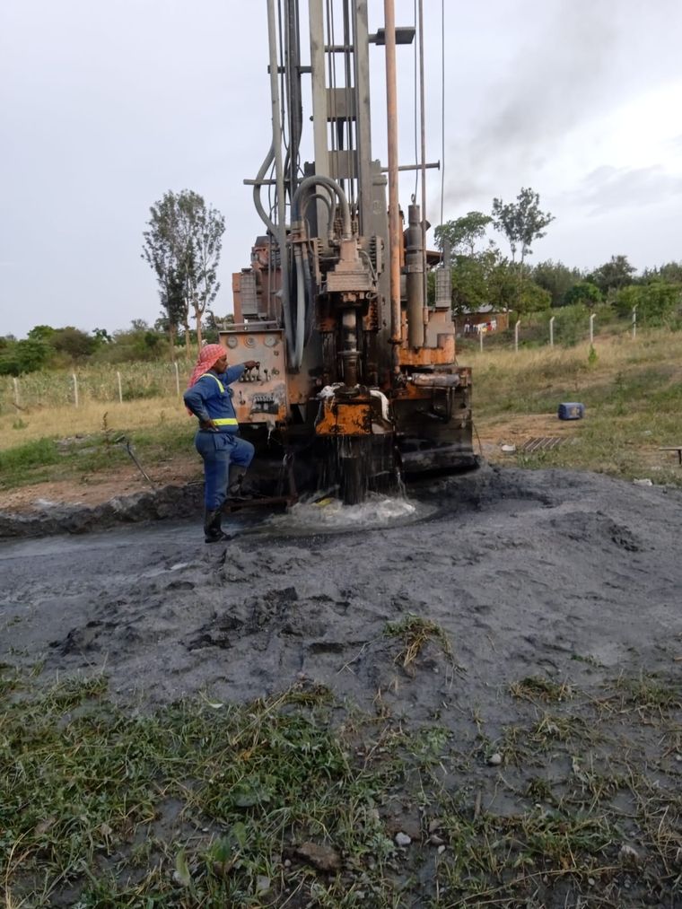 Drilling rig at work on a borehole site with the crew on the platform