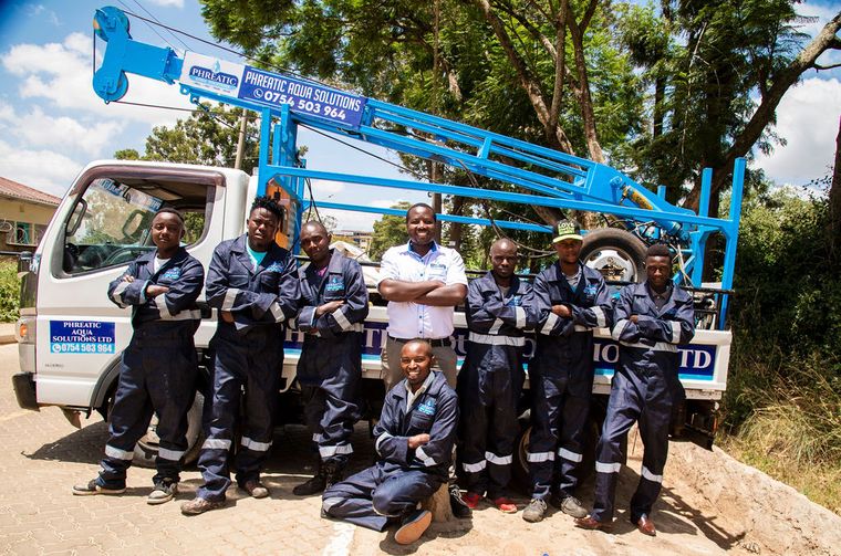 The Phreatic Aqua Solutions field crew standing with a drilling rig