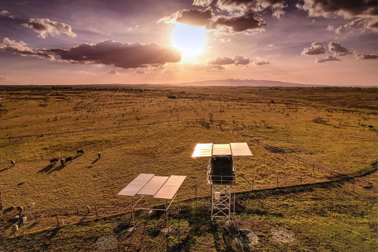 A solar-powered water pumping installation and storage tank at dusk