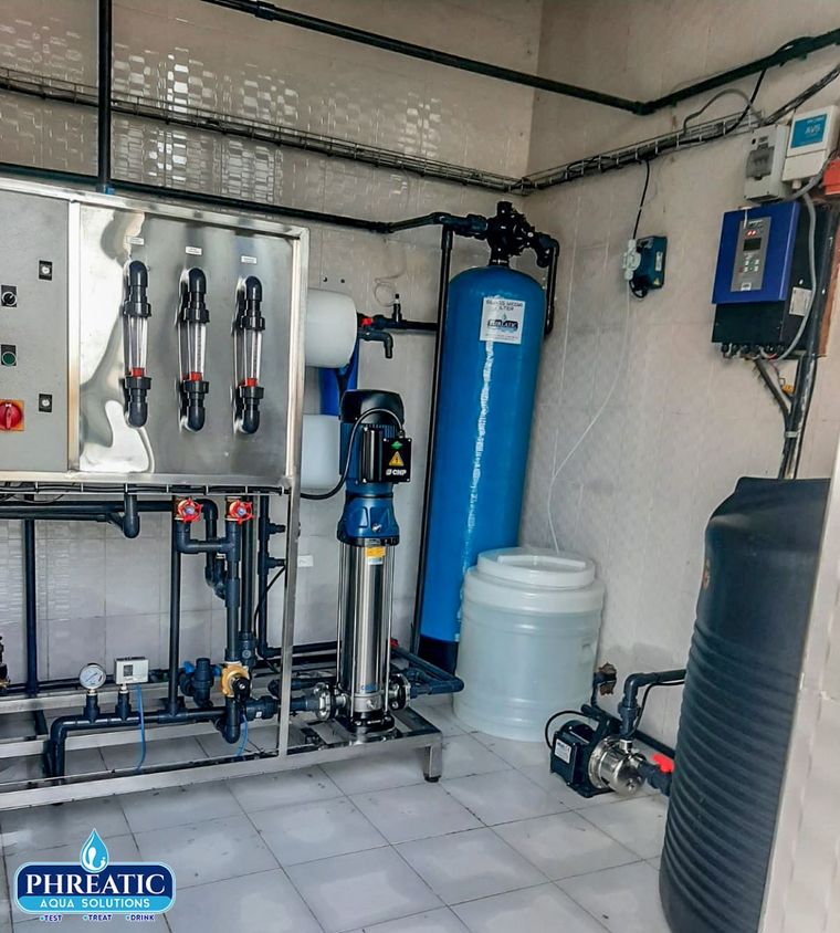 Water treatment control panel and dosing equipment in a plant room