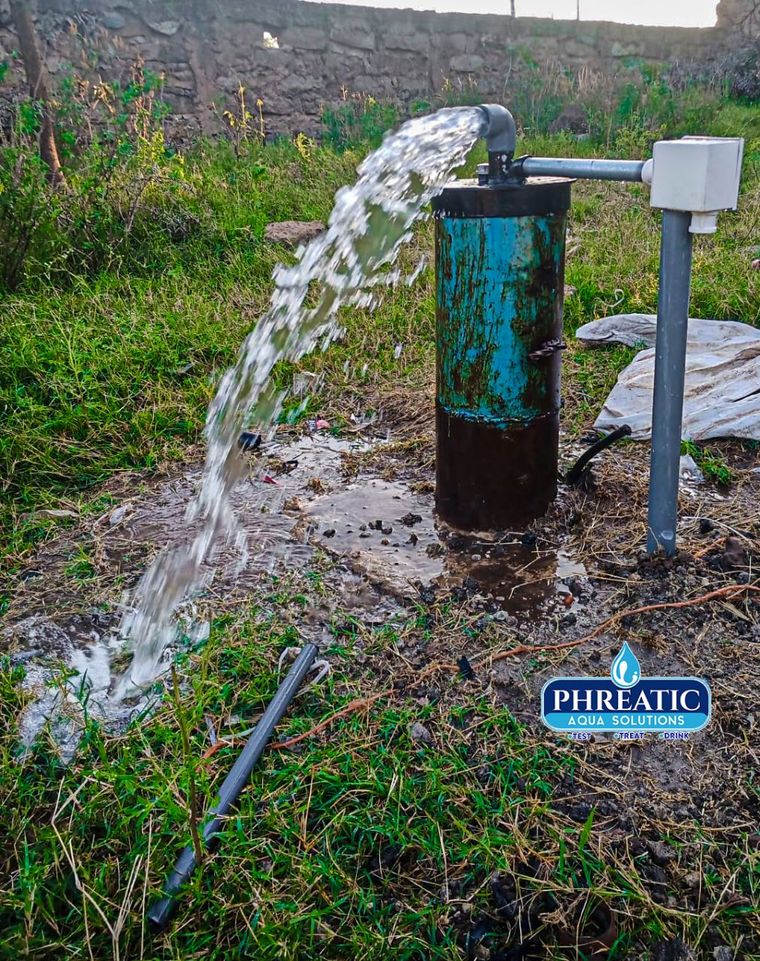 An equipped borehole discharging water at Kenya Israel, Machakos County